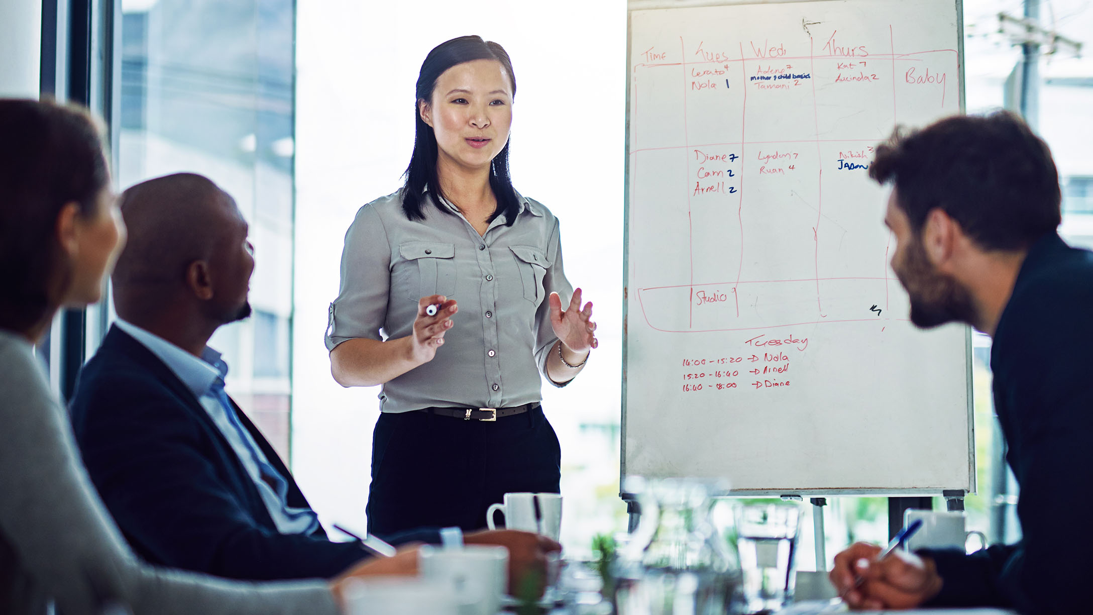 Image of a woman briefing a group of people