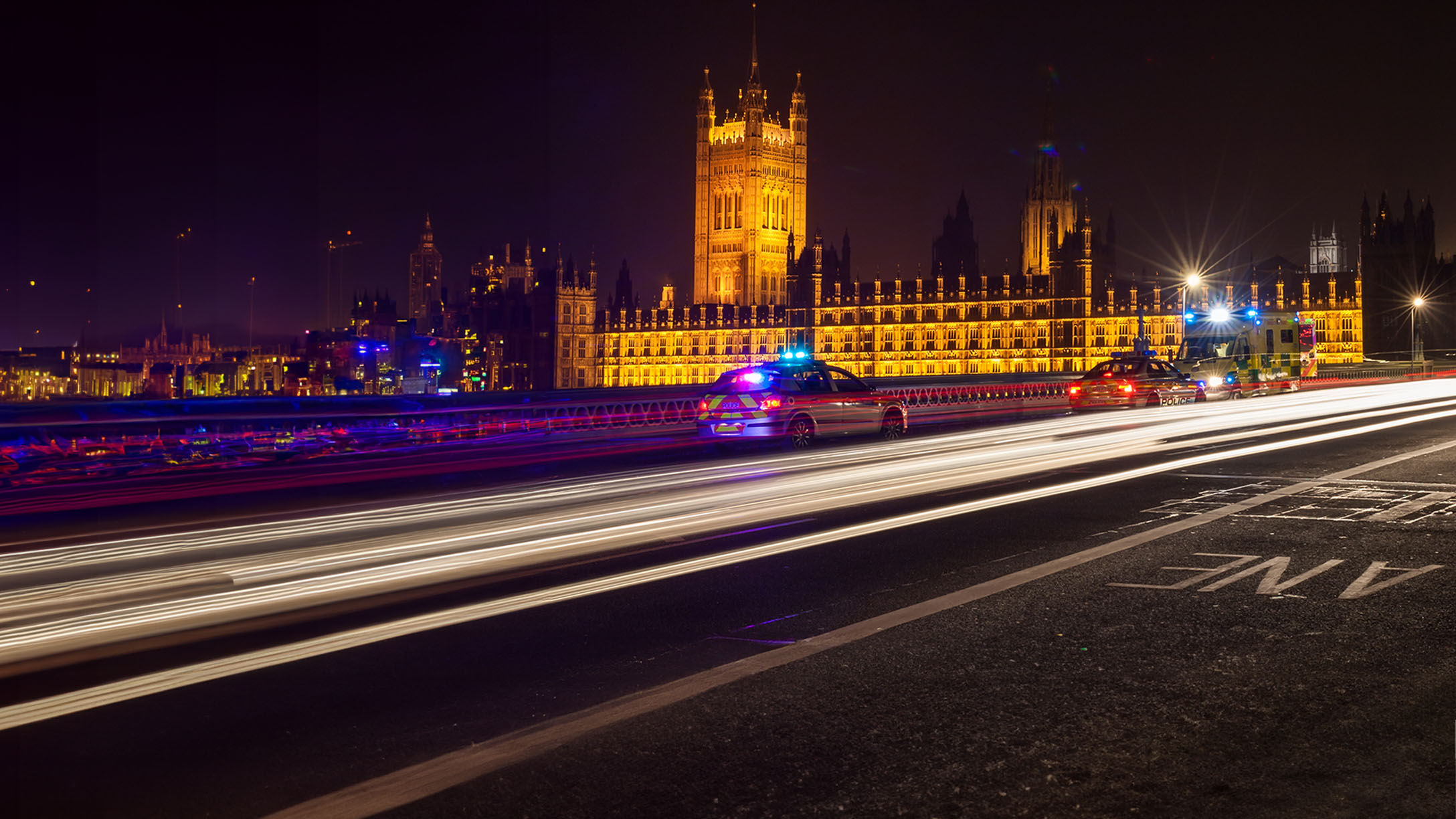 London at night with police cars