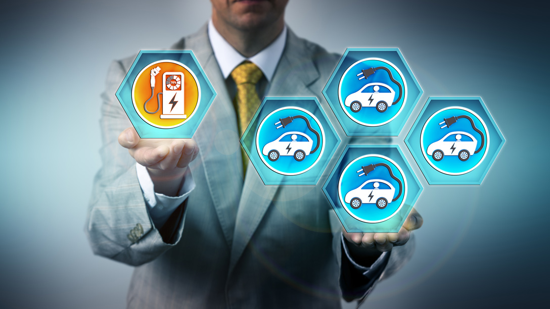 Man in suit holding electric vehicle icons