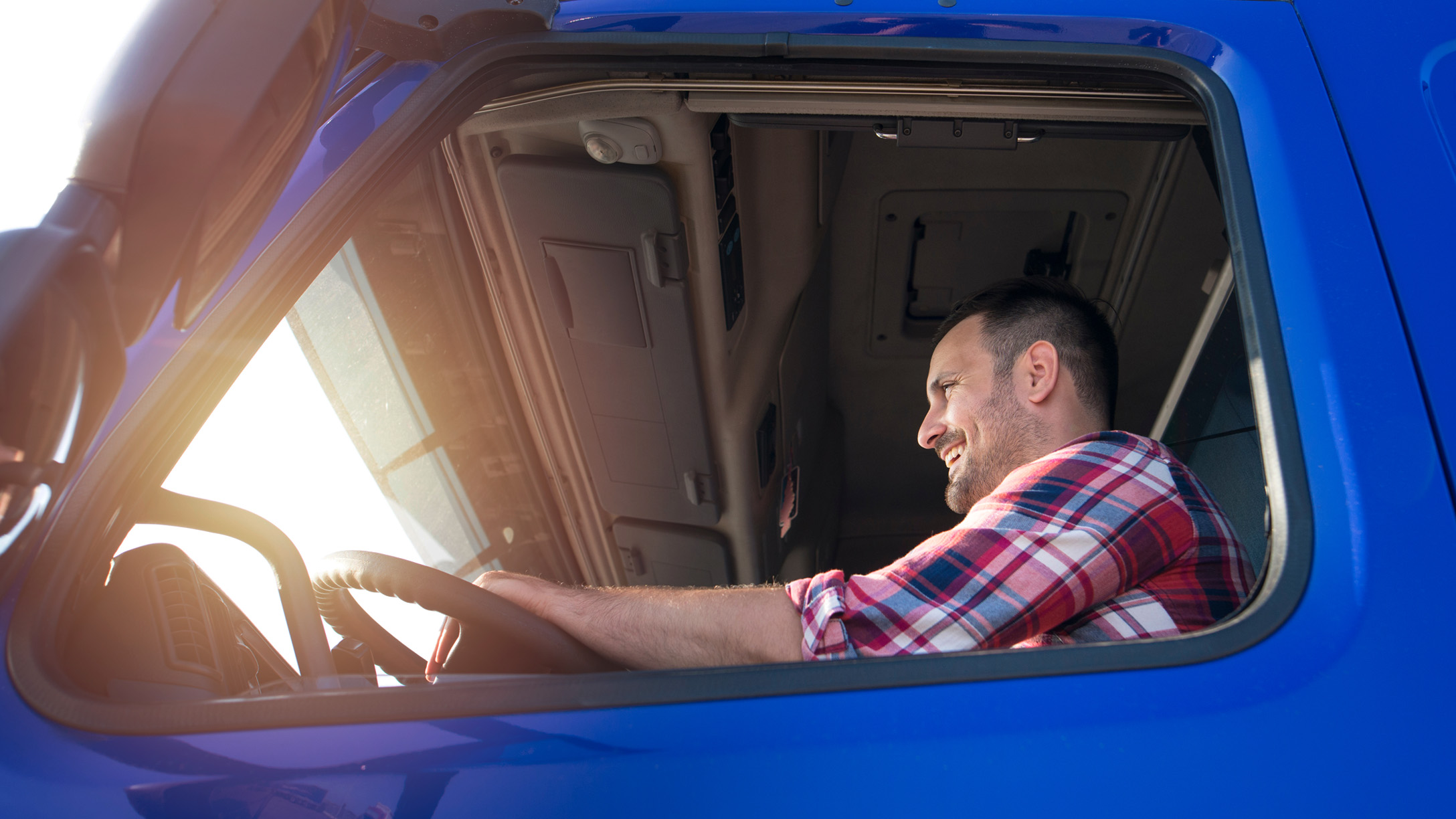 lorry driver holding steering wheel