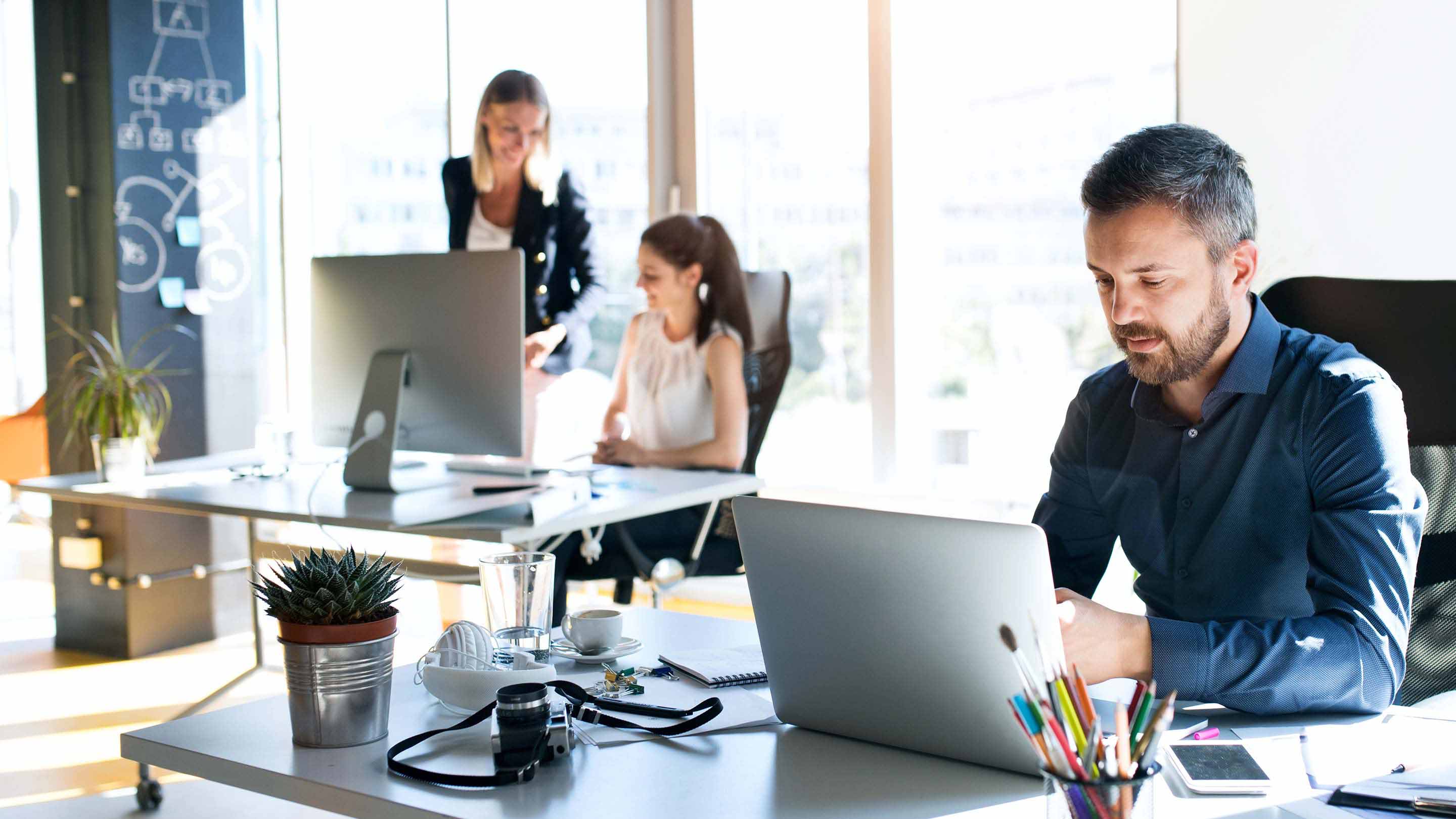 bearded man working on a laptop