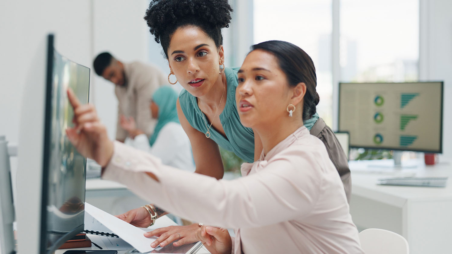 two people looking at a computer