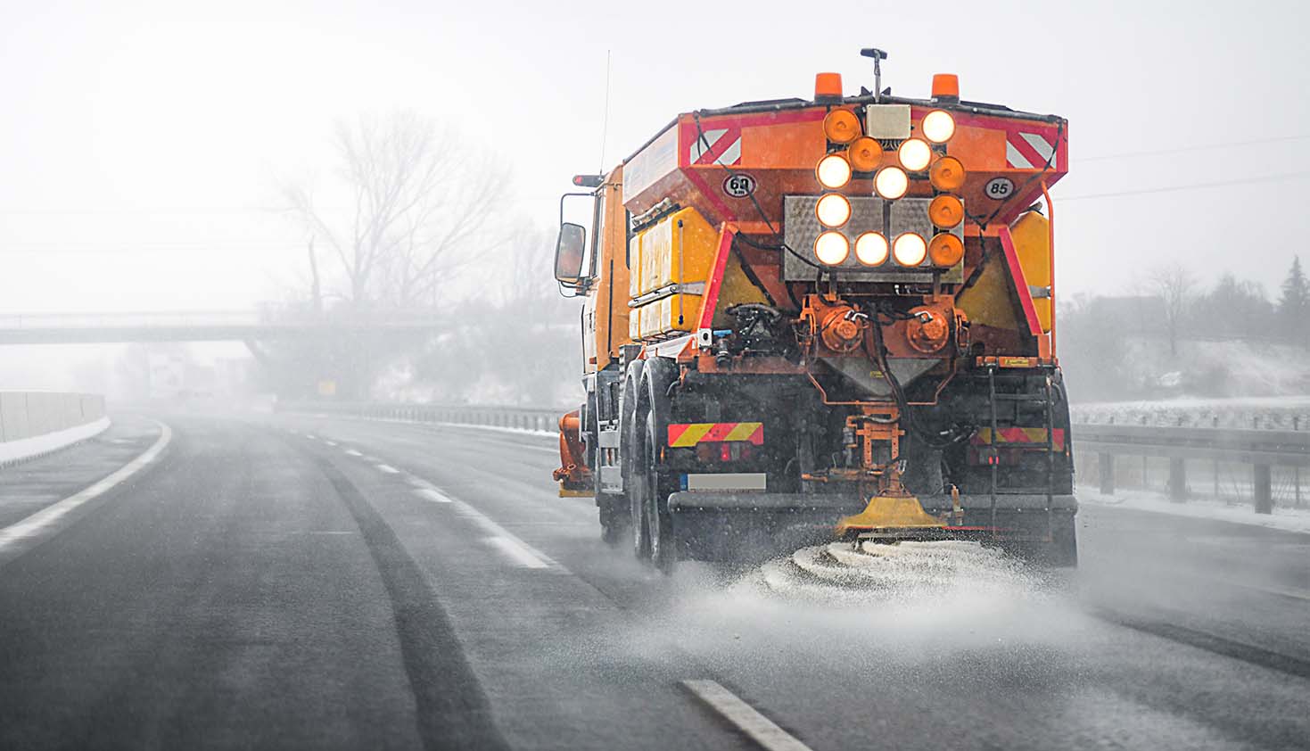 Truck spreading ice salt on a highway