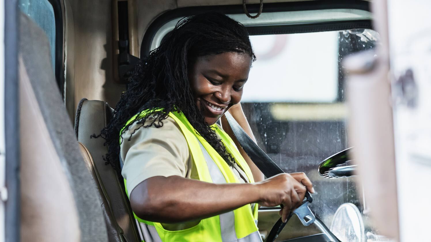 person buckling seatbelt in a truck