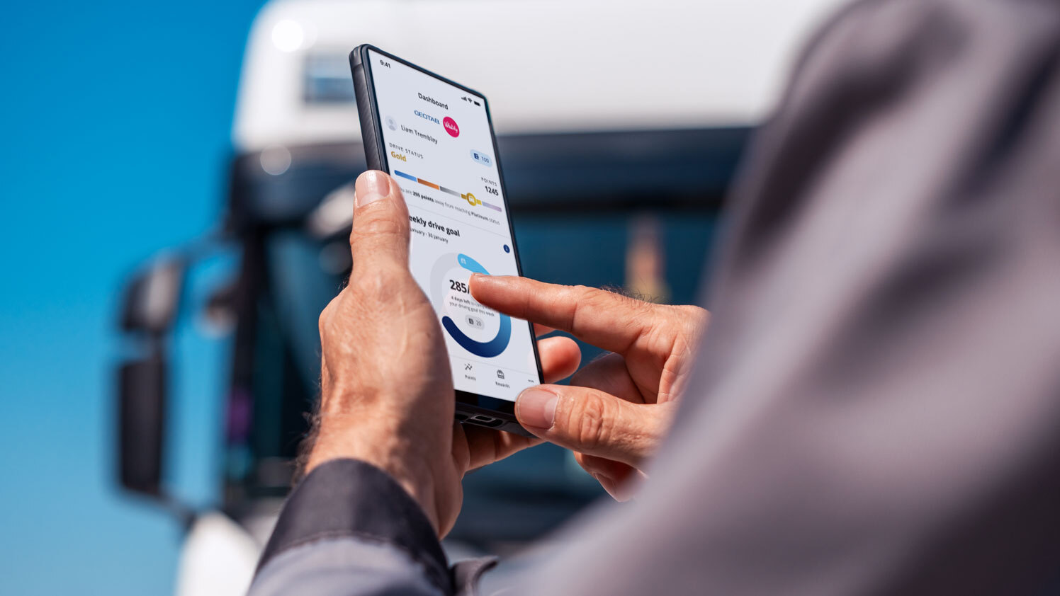 Person using a phone with Geotab Vitality on screen