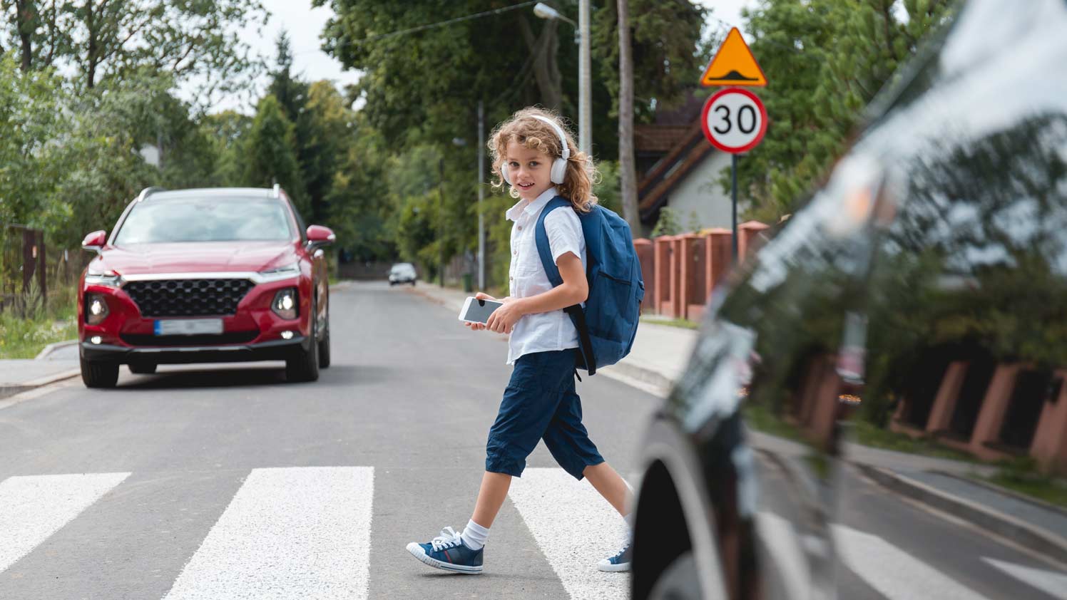 A kid crossing the street safely