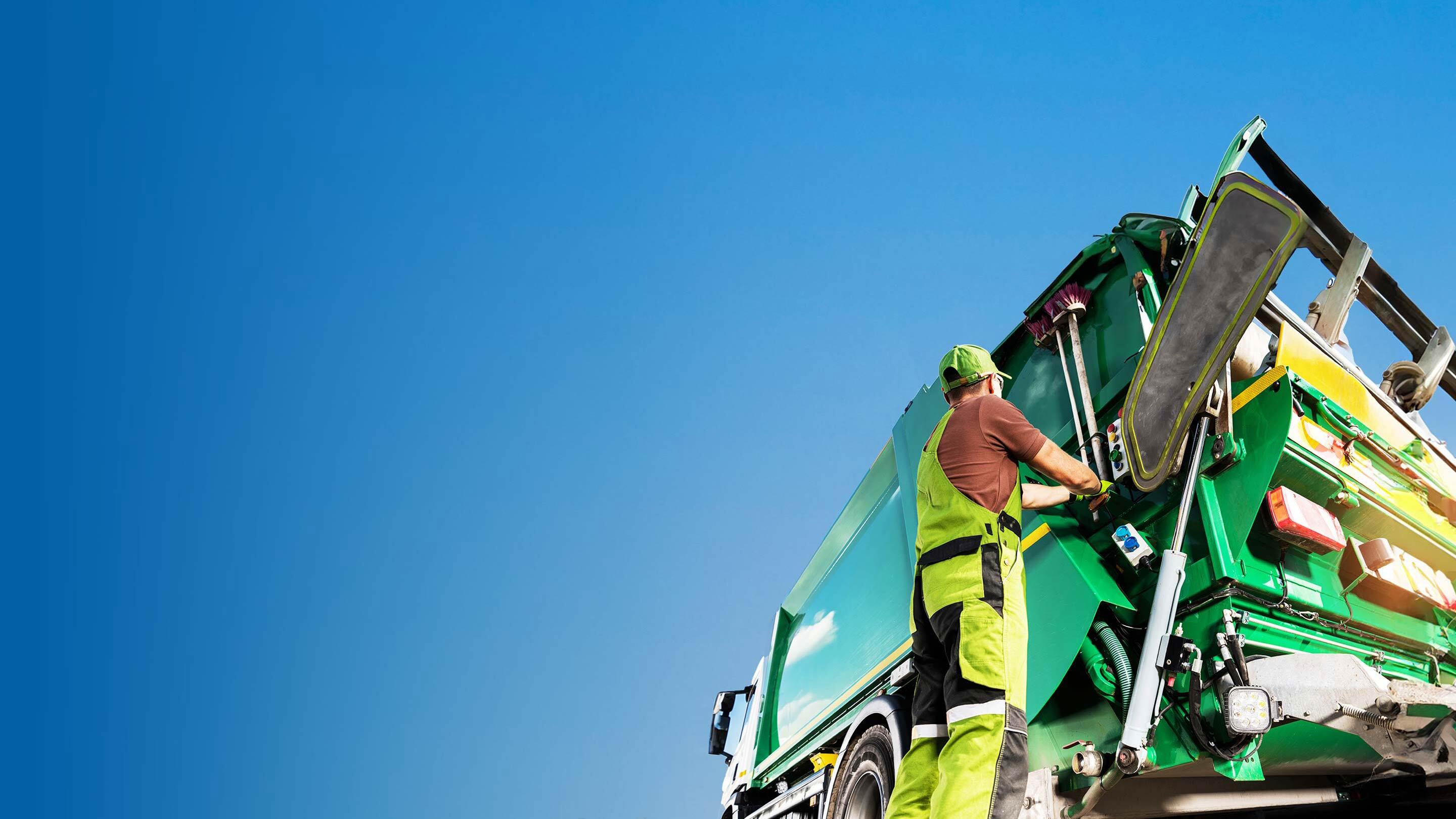 person hanging on the side of a waste disposal truck
