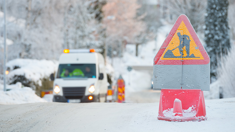 construction sign on a road during winter