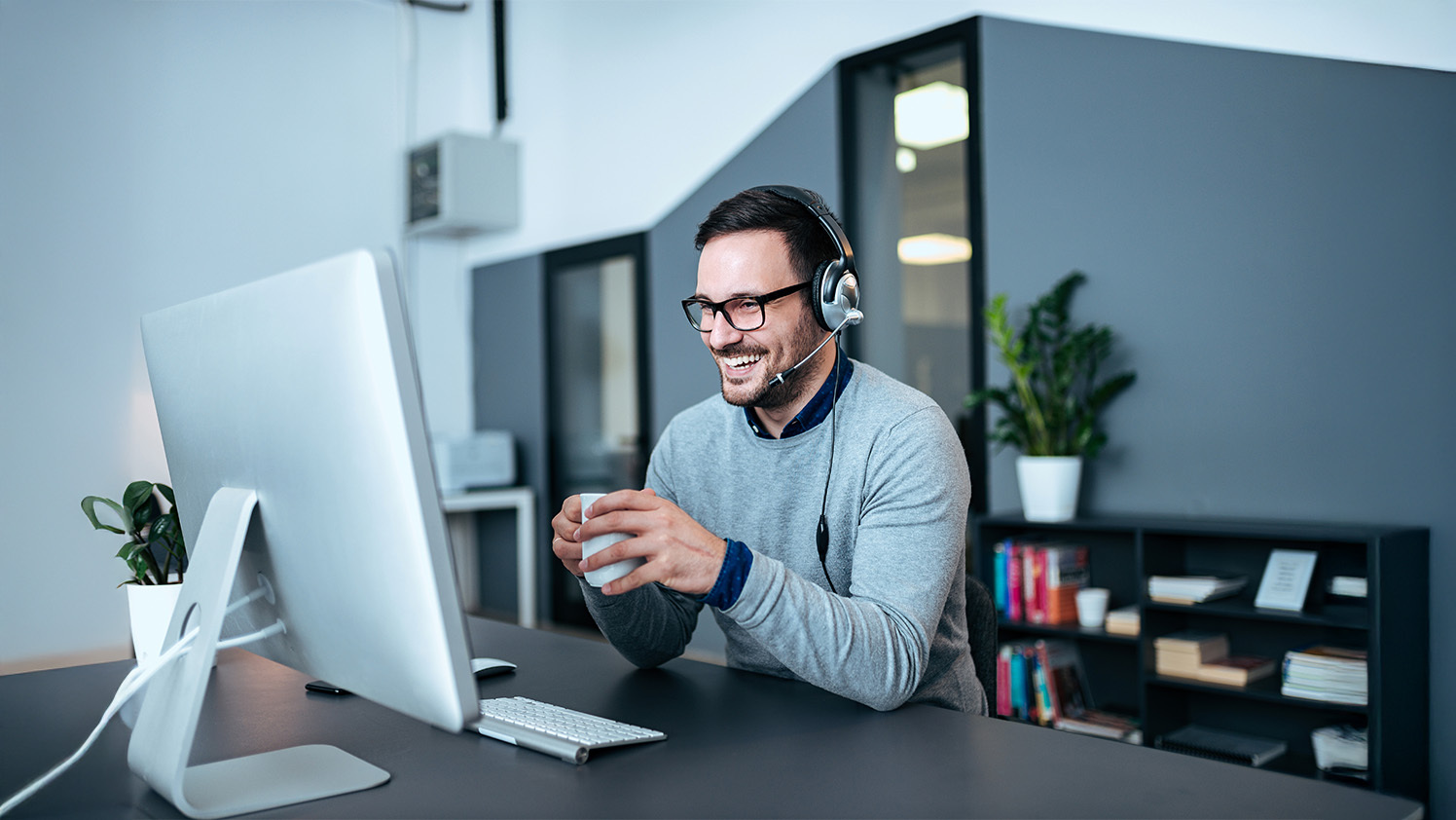 person sitting at a computer smiling