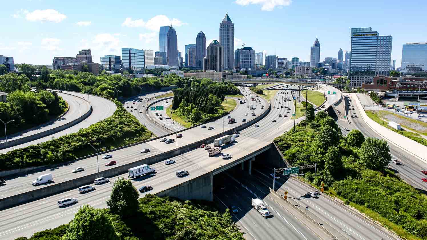 Ariel view of highway with city skyline in the background