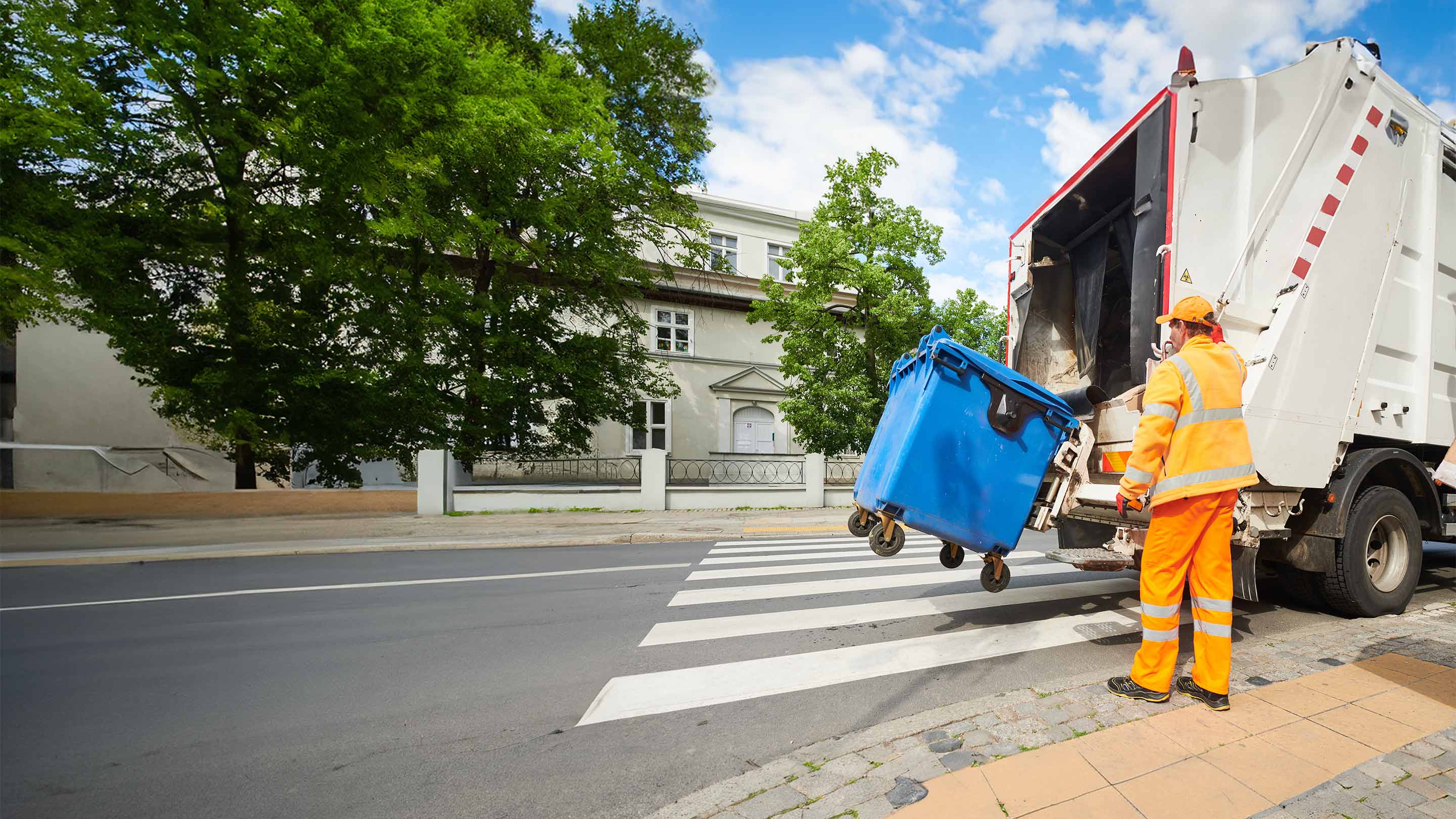 person picking up recycle bin