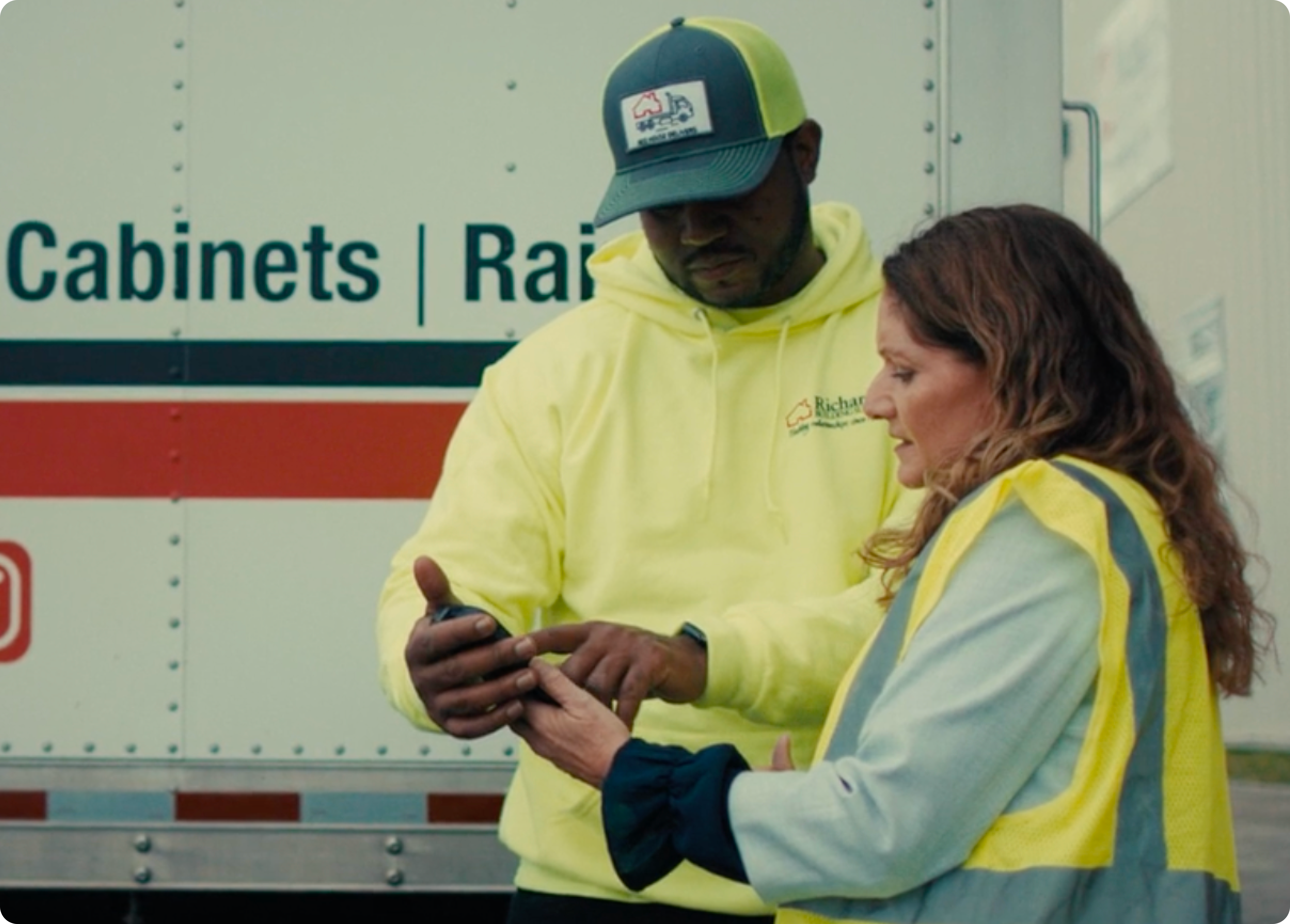 two logistic employees looking at an ipad
